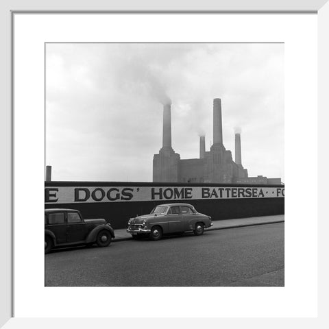Two parked cars with Battersea Power Station in the background. c.1955