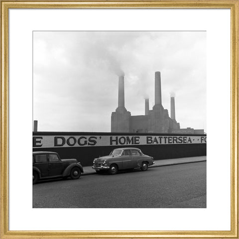 Two parked cars with Battersea Power Station in the background. c.1955