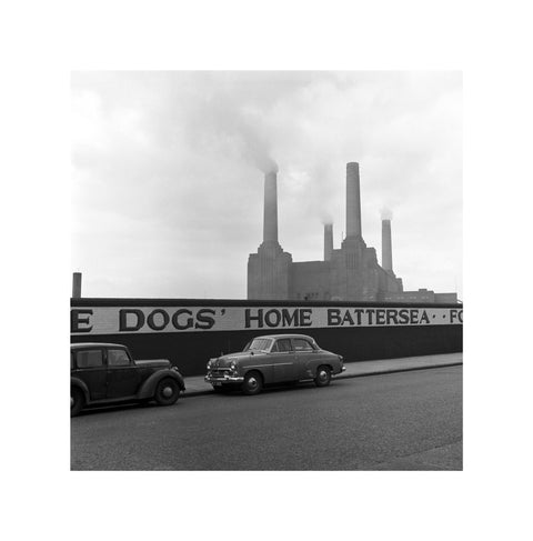 Two parked cars with Battersea Power Station in the background. c.1955