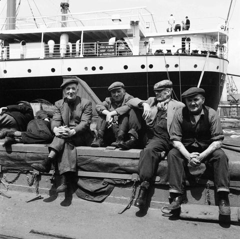 Dockers taking a break on the quayside at London's Docks