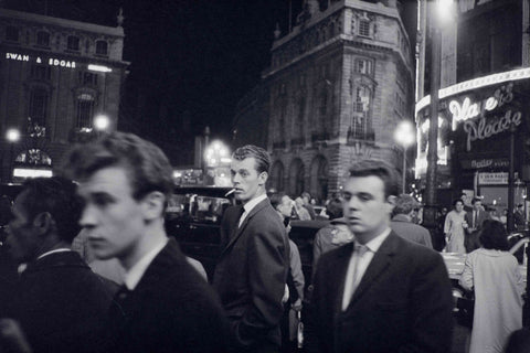 Passers-by on a London street at night