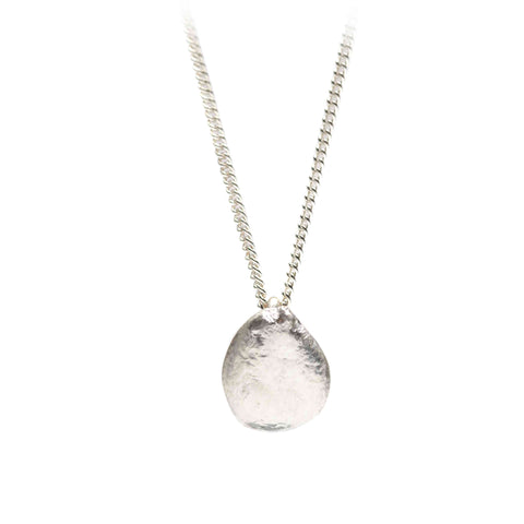 Silver necklace with an irregular round pendant on a white background