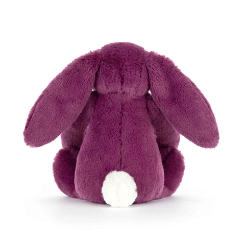 Back view of a plush purple bunny toy on a white background