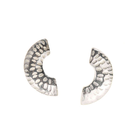 Pair of silver stud earrings with textured design in the shape of a semi-circle on a white background