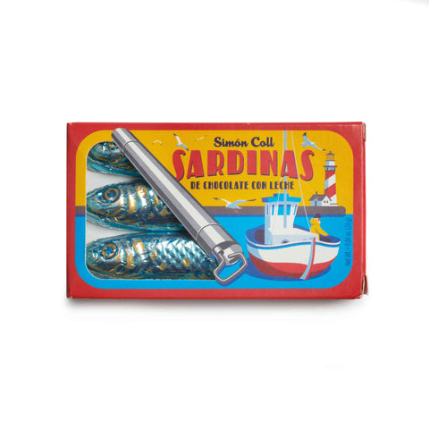 Box of chocolate sardines with a toy boat and tool on a white background