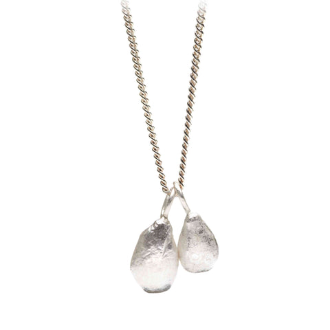 Silver necklace with two irregular teardrop-shaped pendants on a white background