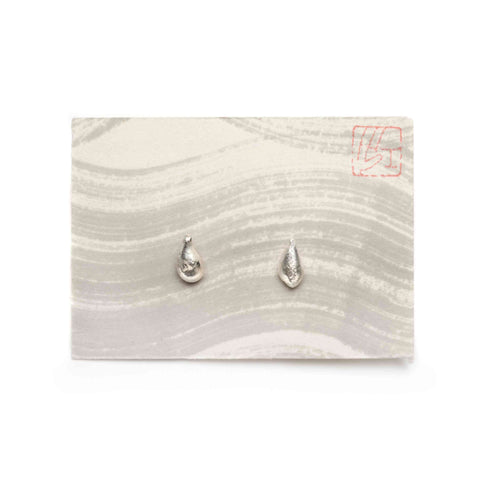 Pair of silver teardrop-shaped stud earrings on a grey wavy-patterned card with visible red logo.
