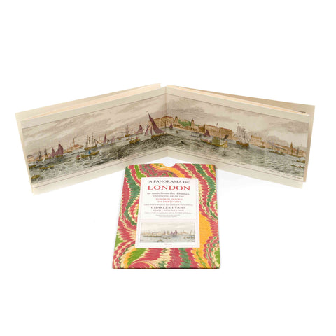 Folded print with a panoramic view of London and a colourful cover on a white background