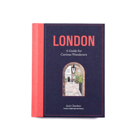 Book cover for London:  A Guide for Curious Wanderers featuring a picture of houses through a brick archway against a blue and red background.