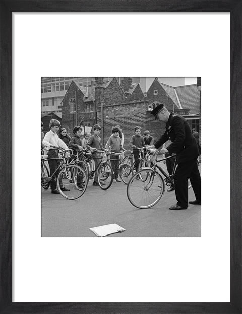 A policeman trains school children for their National Cycling Proficiency test at St. Mary's School, Finchley