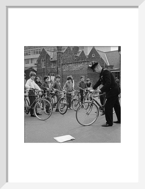 A policeman trains school children for their National Cycling Proficiency test at St. Mary's School, Finchley