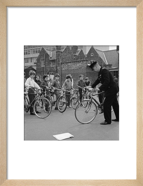 A policeman trains school children for their National Cycling Proficiency test at St. Mary's School, Finchley