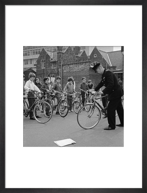 A policeman trains school children for their National Cycling Proficiency test at St. Mary's School, Finchley