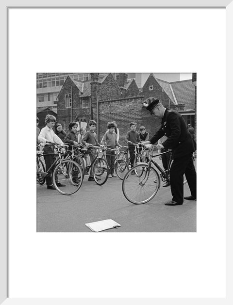 A policeman trains school children for their National Cycling Proficiency test at St. Mary's School, Finchley