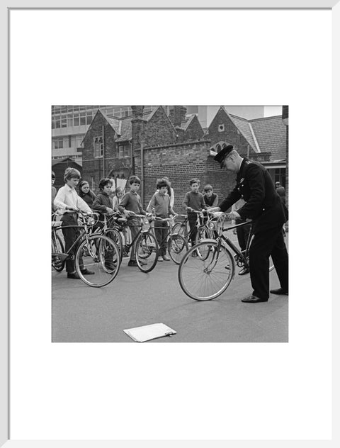 A policeman trains school children for their National Cycling Proficiency test at St. Mary's School, Finchley