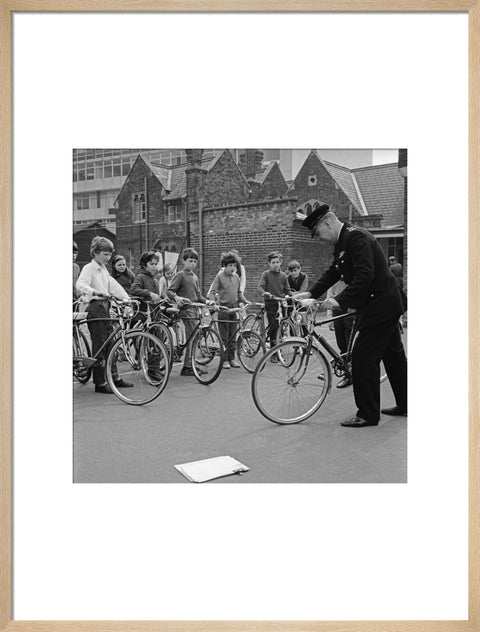 A policeman trains school children for their National Cycling Proficiency test at St. Mary's School, Finchley