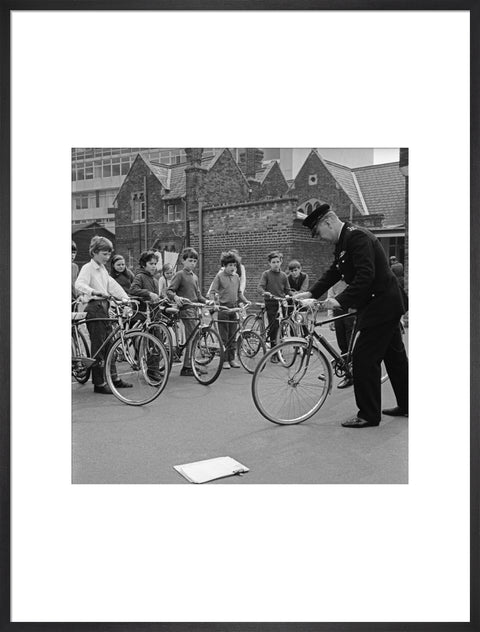 A policeman trains school children for their National Cycling Proficiency test at St. Mary's School, Finchley