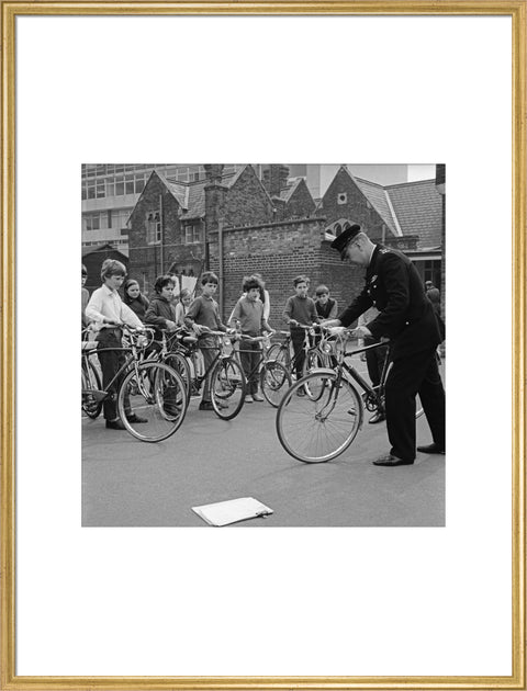 A policeman trains school children for their National Cycling Proficiency test at St. Mary's School, Finchley