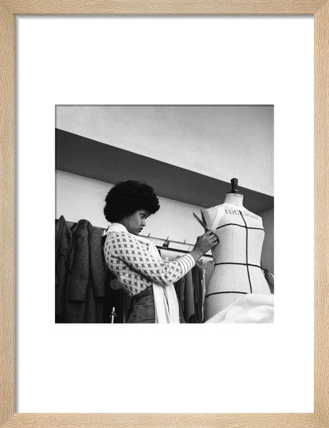 A female student works on a dressmaker's mannequin at Southgate Technical College