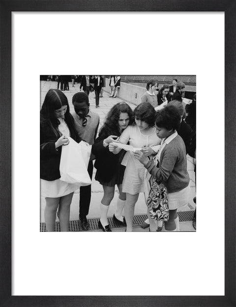School girls receiving school reports or exam results