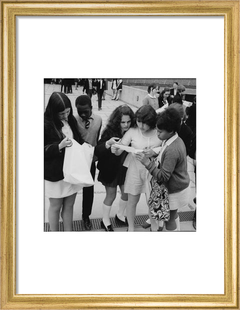 School girls receiving school reports or exam results