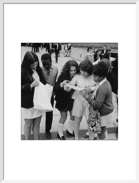 School girls receiving school reports or exam results