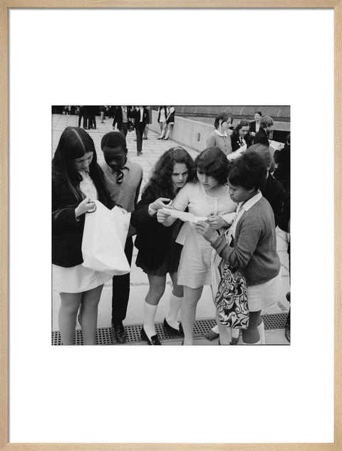 School girls receiving school reports or exam results