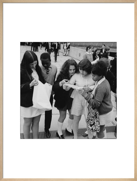 School girls receiving school reports or exam results