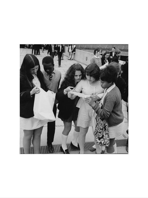 School girls receiving school reports or exam results