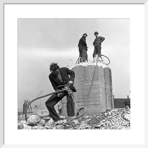 Three men working on a building site.