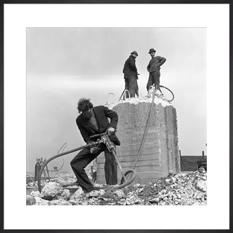 Three men working on a building site.