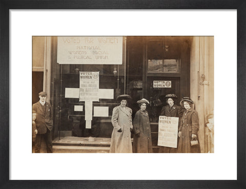 Photographic postcard of leading Suffragettes standing outside a branch shop of the Women's Social and Political Union in Hawick Scotland.