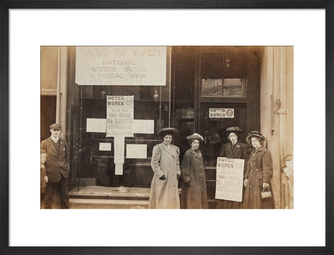 Photographic postcard of leading Suffragettes standing outside a branch shop of the Women's Social and Political Union in Hawick Scotland.