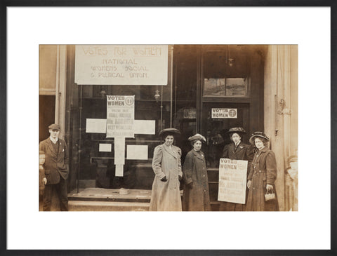 Photographic postcard of leading Suffragettes standing outside a branch shop of the Women's Social and Political Union in Hawick Scotland.