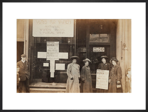 Photographic postcard of leading Suffragettes standing outside a branch shop of the Women's Social and Political Union in Hawick Scotland.