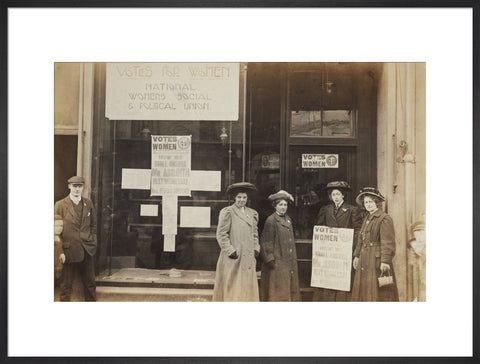 Photographic postcard of leading Suffragettes standing outside a branch shop of the Women's Social and Political Union in Hawick Scotland.