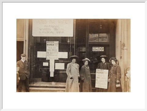 Photographic postcard of leading Suffragettes standing outside a branch shop of the Women's Social and Political Union in Hawick Scotland.