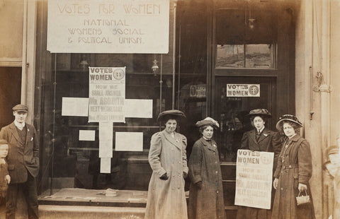 Photographic postcard of leading Suffragettes standing outside a branch shop of the Women's Social and Political Union in Hawick Scotland.