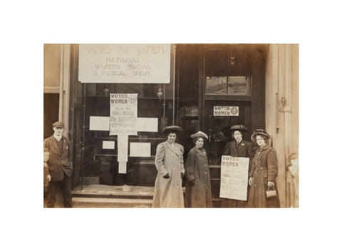 Photographic postcard of leading Suffragettes standing outside a branch shop of the Women's Social and Political Union in Hawick Scotland.