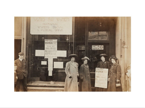 Photographic postcard of leading Suffragettes standing outside a branch shop of the Women's Social and Political Union in Hawick Scotland.