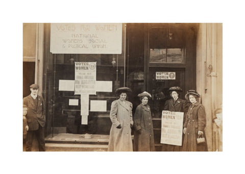 Photographic postcard of leading Suffragettes standing outside a branch shop of the Women's Social and Political Union in Hawick Scotland.