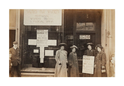 Photographic postcard of leading Suffragettes standing outside a branch shop of the Women's Social and Political Union in Hawick Scotland.