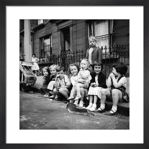Children sitting on the curb Maida Vale 1960