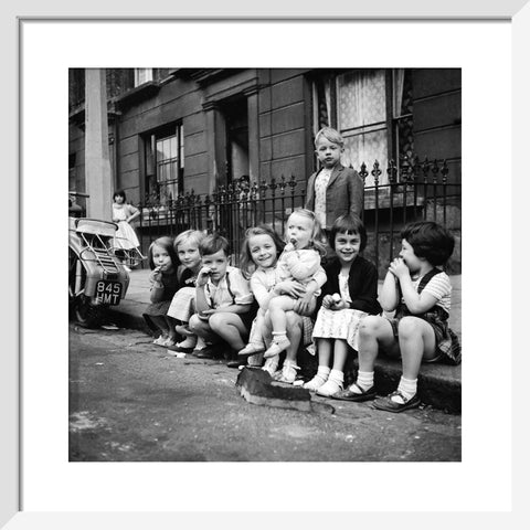 Children sitting on the curb Maida Vale 1960