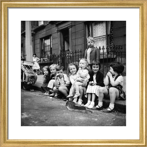Children sitting on the curb Maida Vale 1960