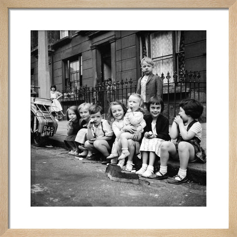 Children sitting on the curb Maida Vale 1960