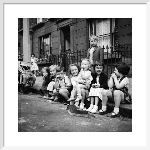 Children sitting on the curb Maida Vale 1960