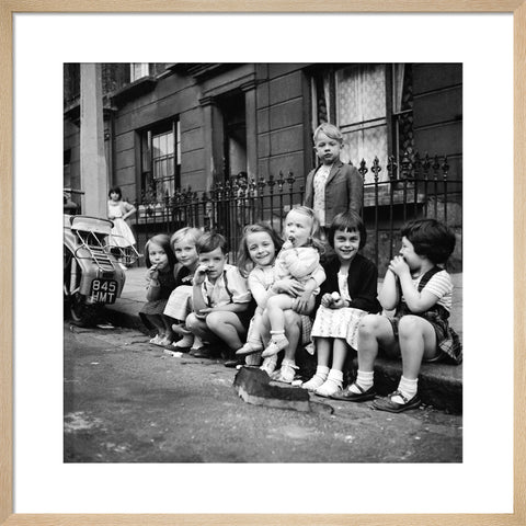 Children sitting on the curb Maida Vale 1960