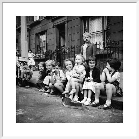 Children sitting on the curb Maida Vale 1960