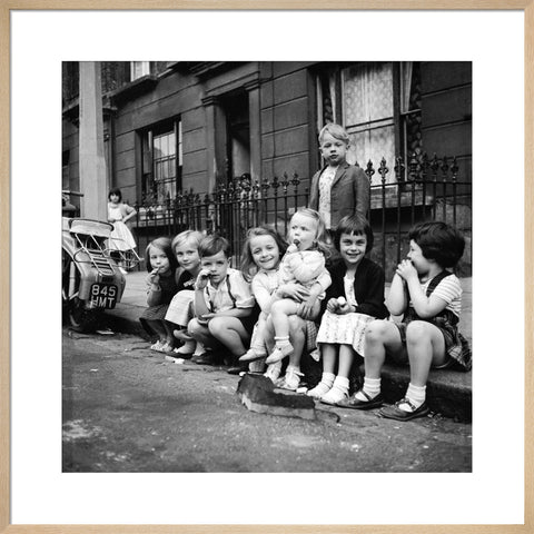 Children sitting on the curb Maida Vale 1960